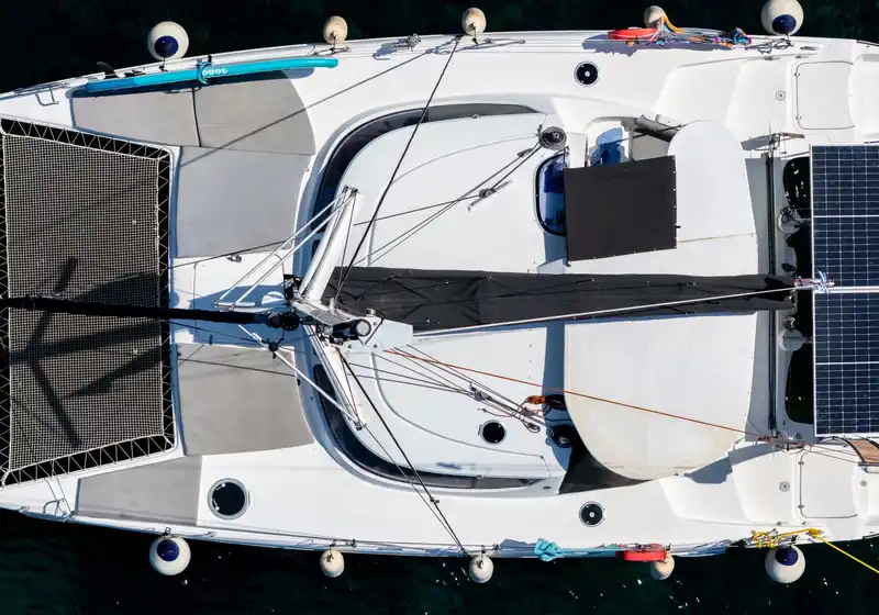 Catamaran at anchor at Agia Kyriaki with its trampoline nets, seen from directly above