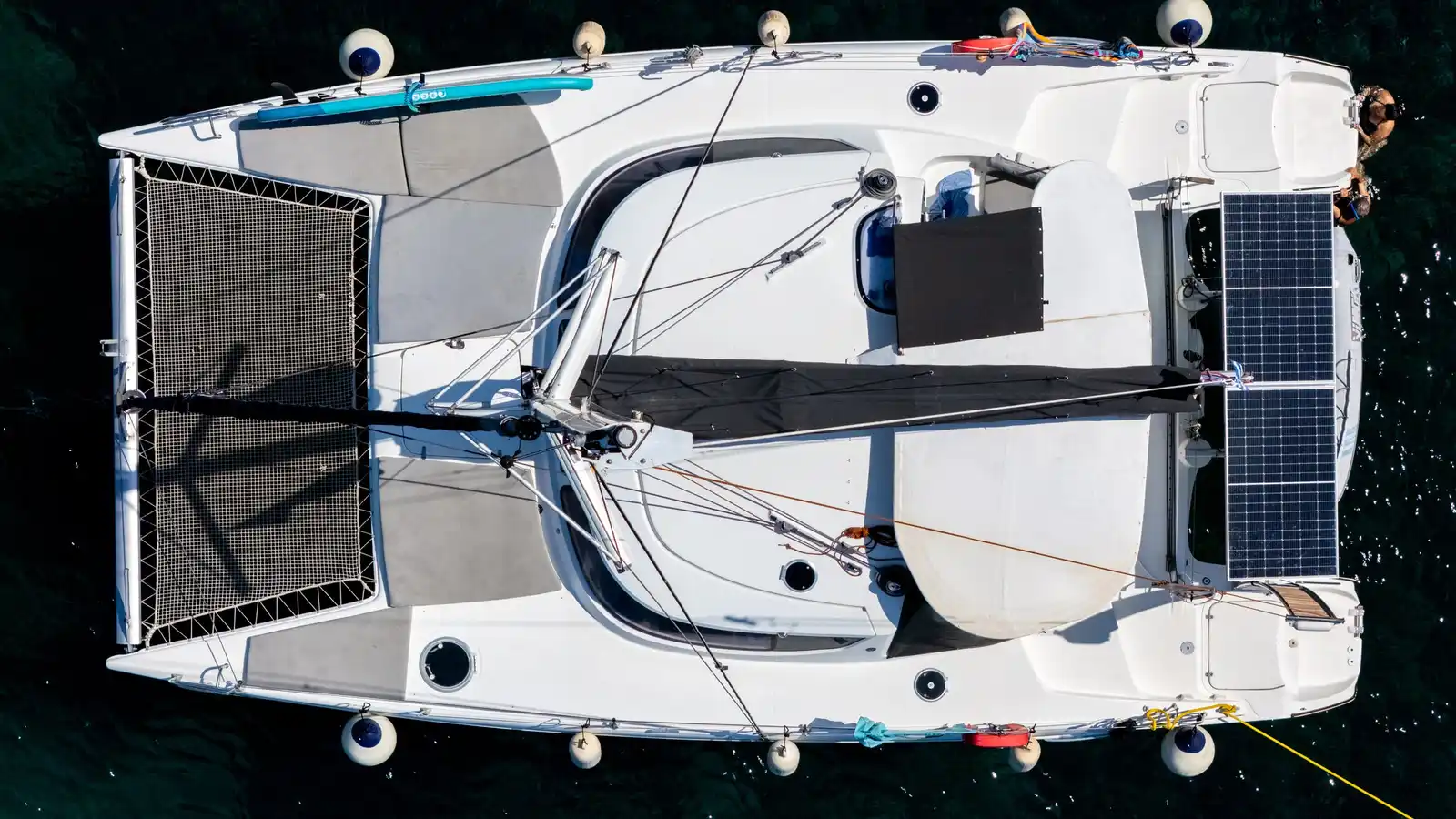 Catamaran at anchor at Agia Kyriaki with its trampoline nets, seen from directly above