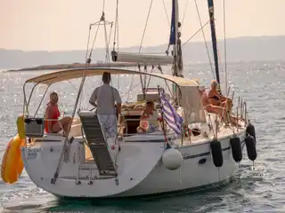 Η πρύμνη του Bavaria 40 Babasails στο χρυσό απογευματινό φως, με επισκέπτες στο κόκπιτ