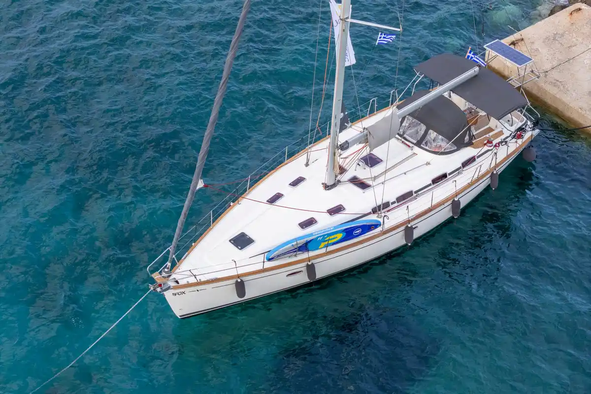 Bavaria 46 Fox moored at the Chrousso pier in Paliouri, seen from above over clear blue water