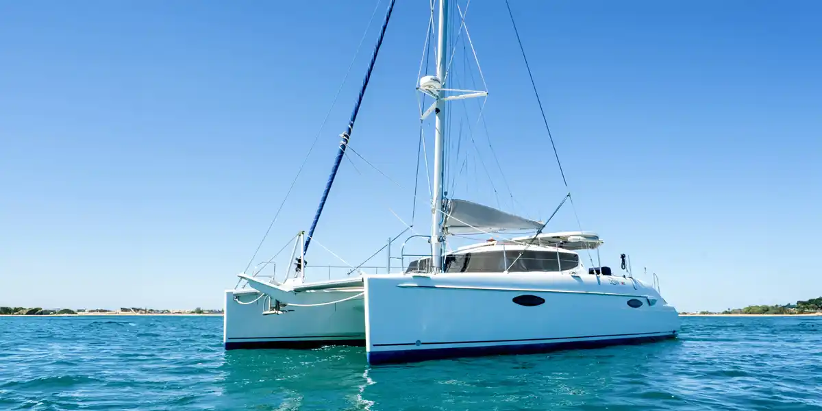 Catamaran at anchor in turquoise water under a clear sky