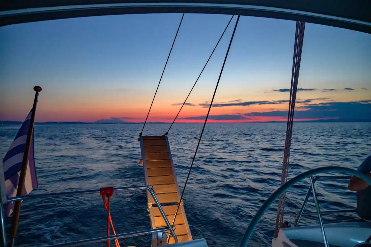 Swim ladder and wake at a sailing yacht’s stern at dusk